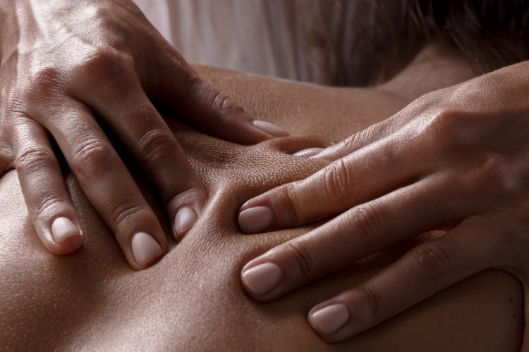 Hands gently massaging a back